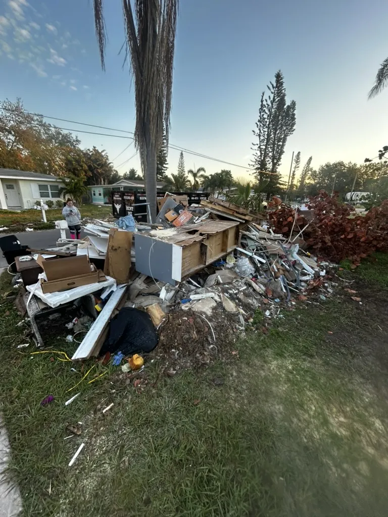 Demolition debris and torn-out materials hauled to the curb for removal