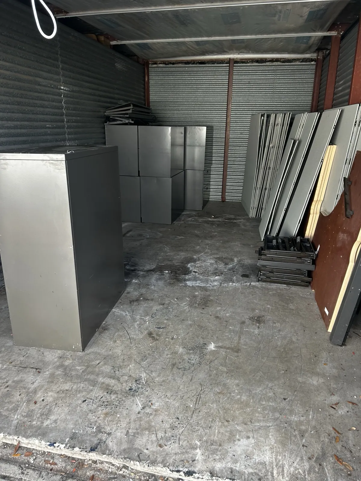 Office desks and cabinets staged for removal during a commercial cleanout